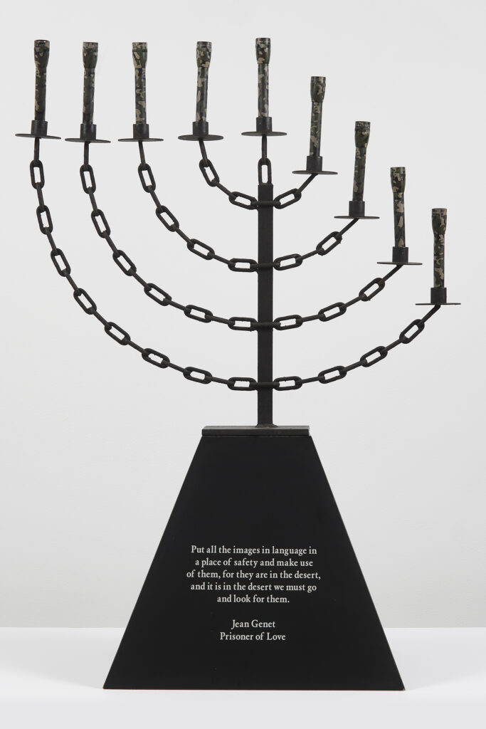 John Boskovich Bondage Menorah 1997 Metal, U.S. issue camouflage mini-maglites, and black formica base with text. 41 1/2 x 30 x 16 1/2 inches 105.4 x 76.2 x 41.9 cm BOSJO005 frieze LA